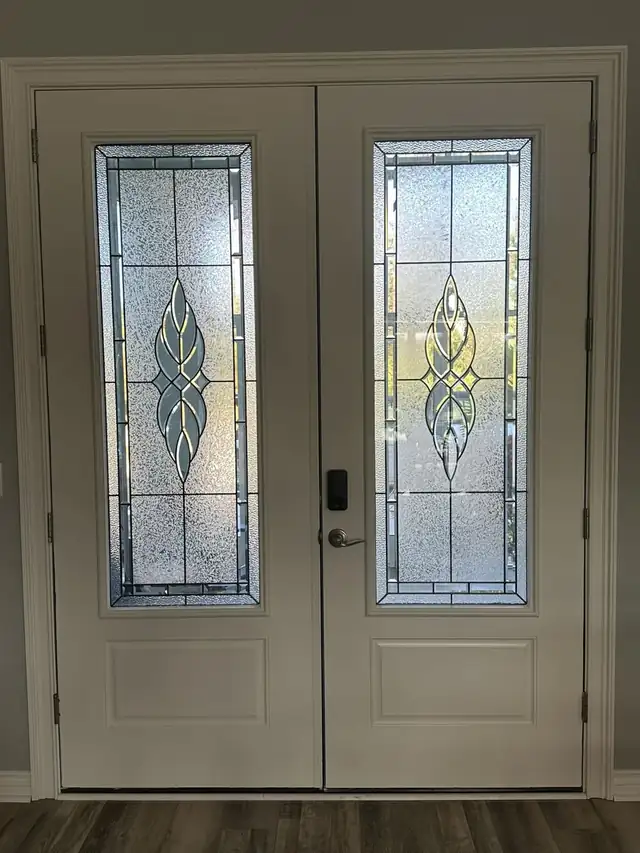 White double entry doors with tall decorative leaded glass inserts